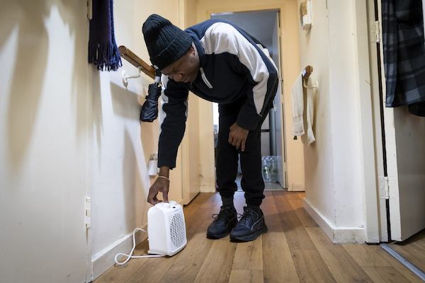 Older man using a dehumidifier in his house